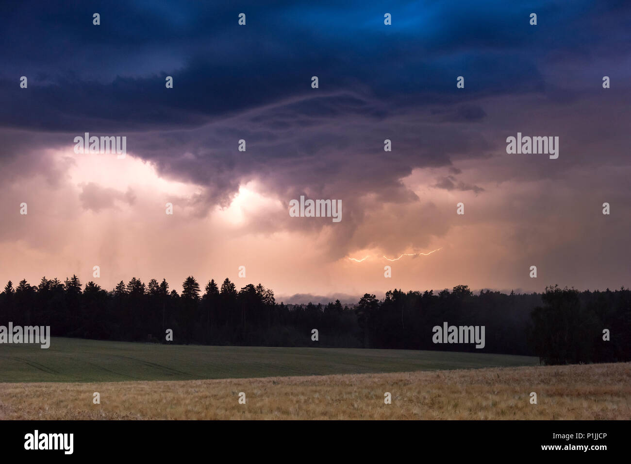 Updraft base and nighttime lightnings near Arnstadt, Thuringia, Germany Stock Photo