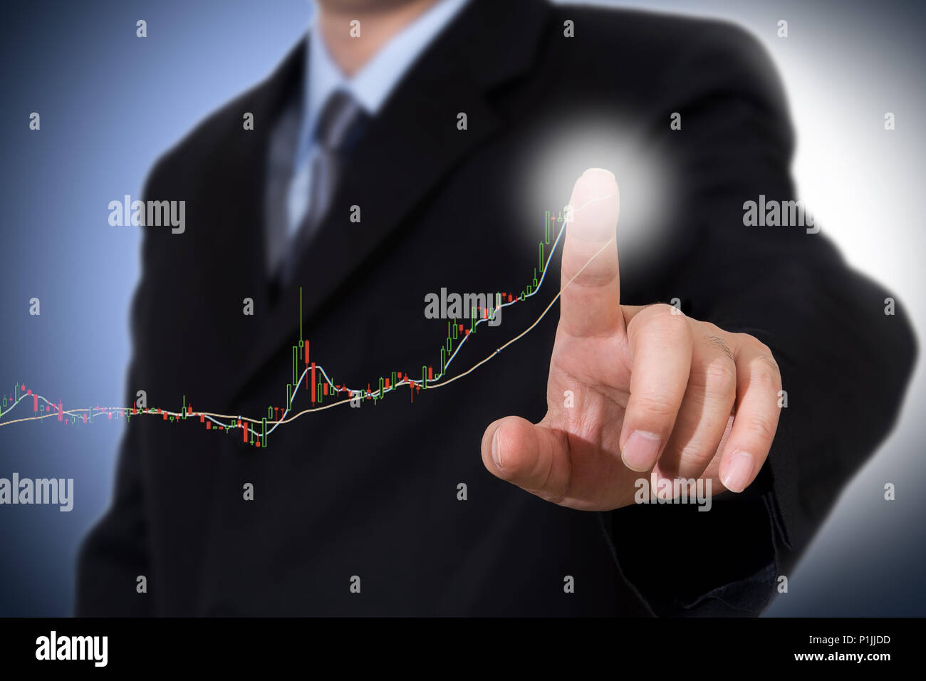 Businessman Touching a Graph Indicating Growth. Stock Photo