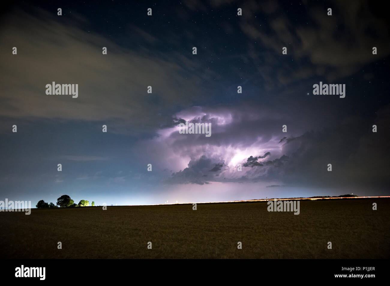 Thunderstorm with sheet lightning under the starry sky near Butzbach, Hessia, Germany Stock Photo