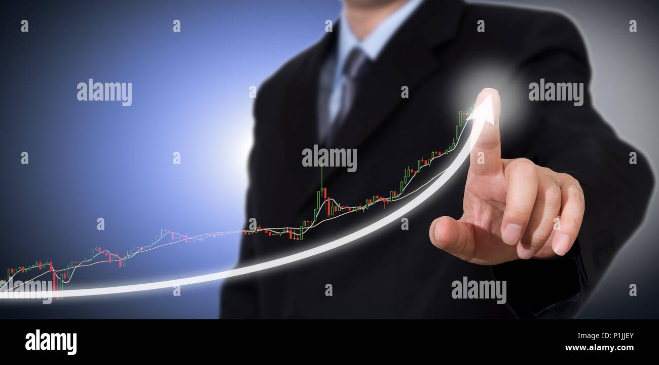 Businessman Touching a Graph Indicating Growth. Stock Photo