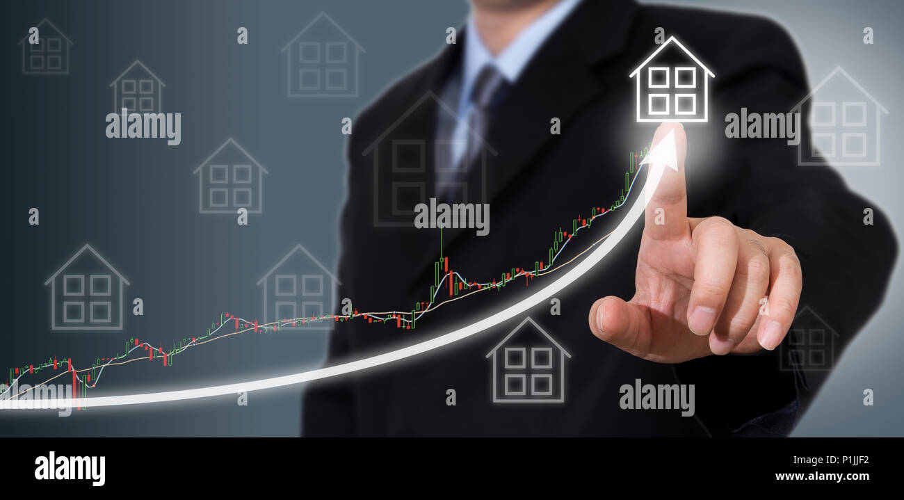 Businessman Touching a Graph Indicating Growth. Stock Photo