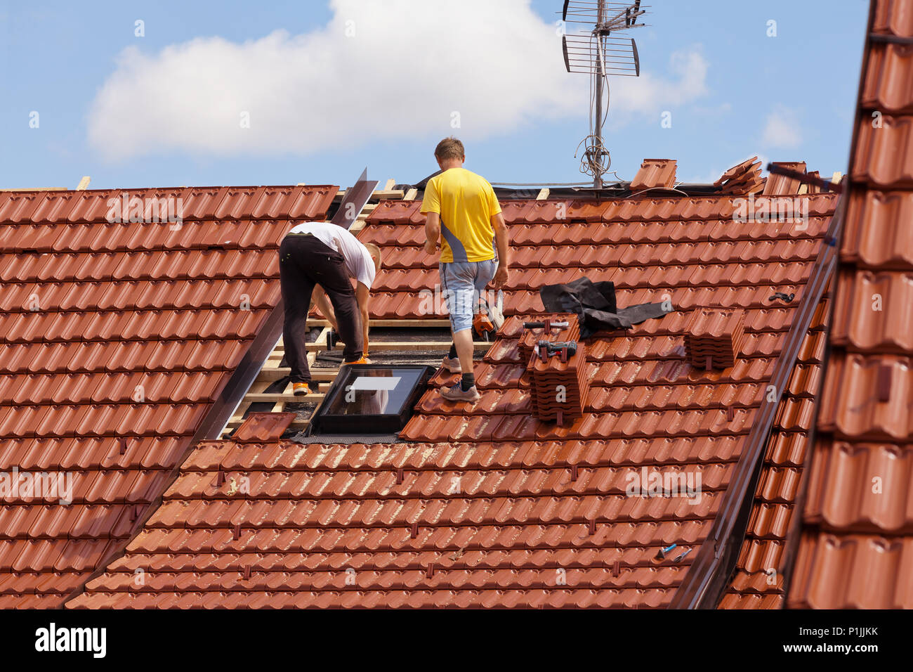 Workers in the roof Stock Photo