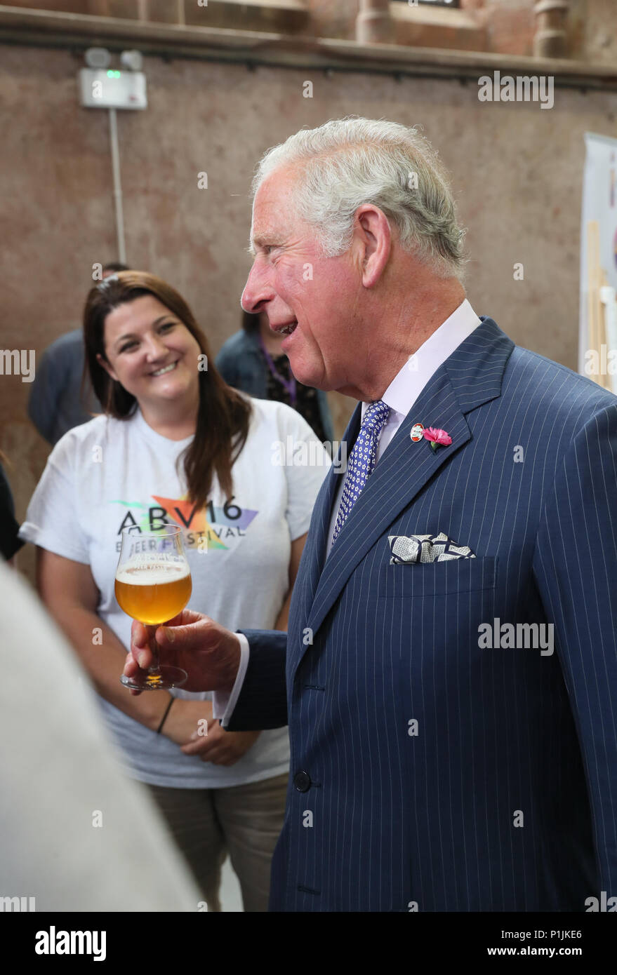 The Prince of Wales holds a glass of beer as he meets representatives of the ABVFest beer festival at Carlisle Memorial Church in Belfast where he is meeting the organisations involved in the regeneration of the building, which hosts the festival. Stock Photo