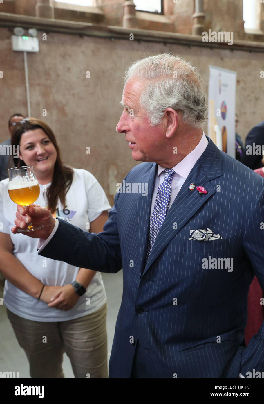 The Prince of Wales holds a glass of beer as he meets representatives of the ABVFest beer festival at Carlisle Memorial Church in Belfast where he is meeting the organisations involved in the regeneration of the building, which hosts the festival. Stock Photo