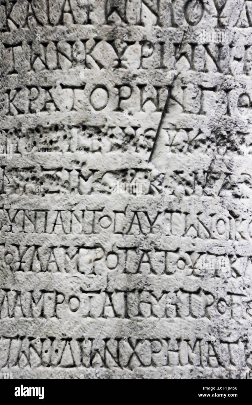 Fragment of a Ancient Greek inscription on a stone column Stock Photo