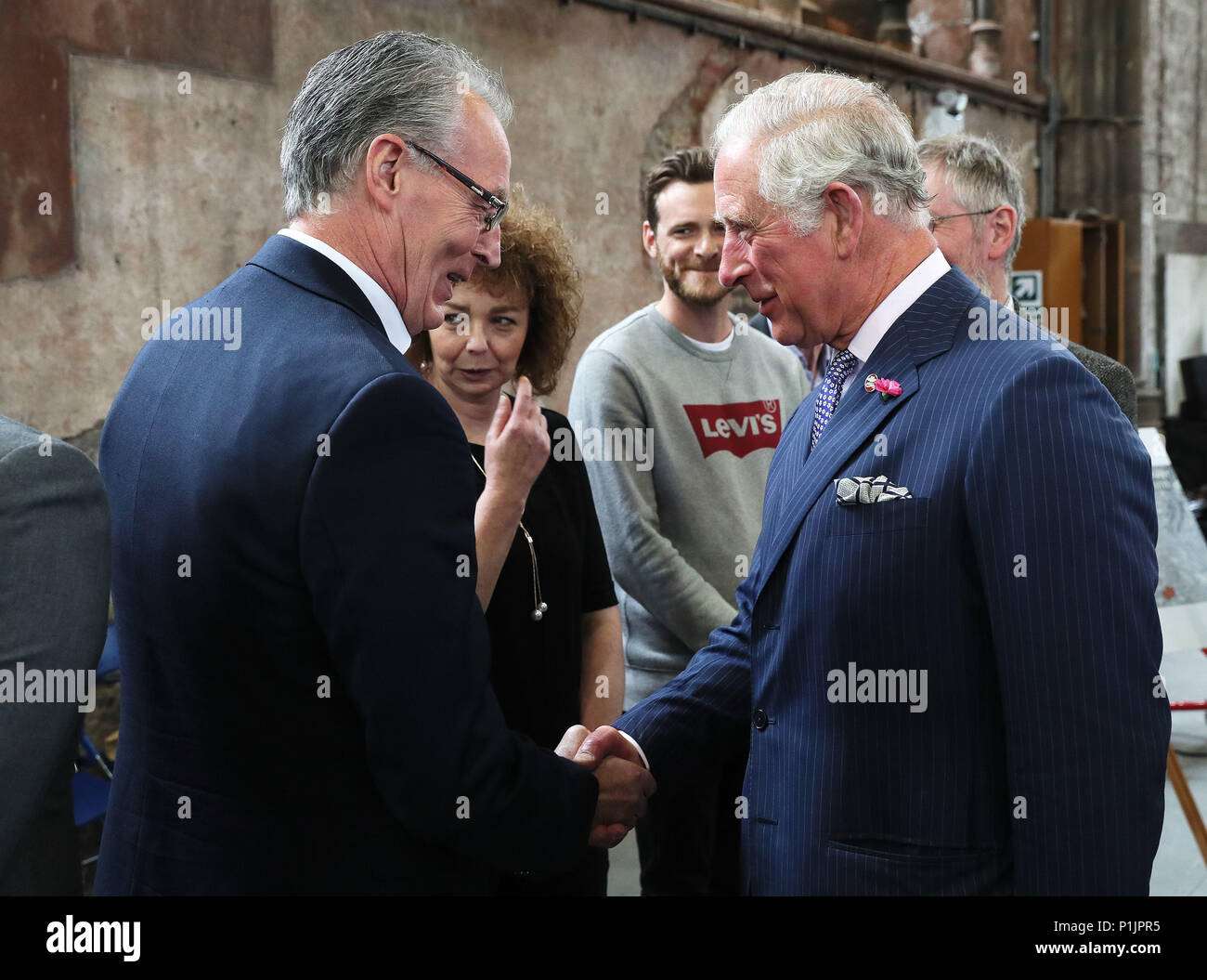 The Prince of Wales shakes hands with Sinn Fein MLA Gerry Kelly as her colleague Caral Ni Chuilin (second left) looks on at Carlisle Memorial Church in Belfast, where Charles is meeting the organisations involved in the regeneration of the building as a permanent home for the Ulster Orchestra. Picture date: Tuesday June 12, 2018. See PA story ROYAL Charles. Photo credit should read: Brian Lawless/PA Wire Stock Photo