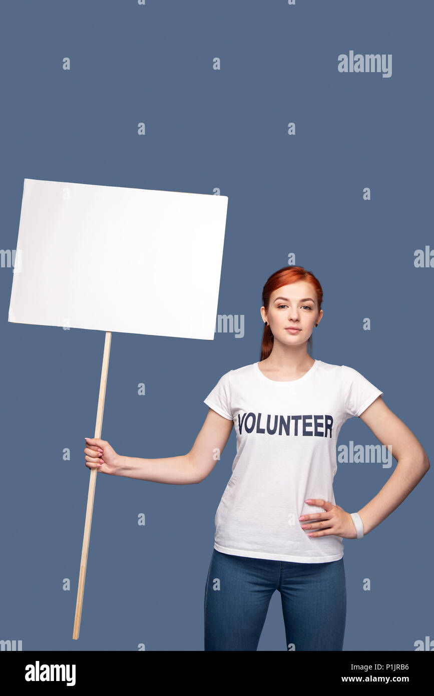 Serious young woman holding a sign Stock Photo - Alamy