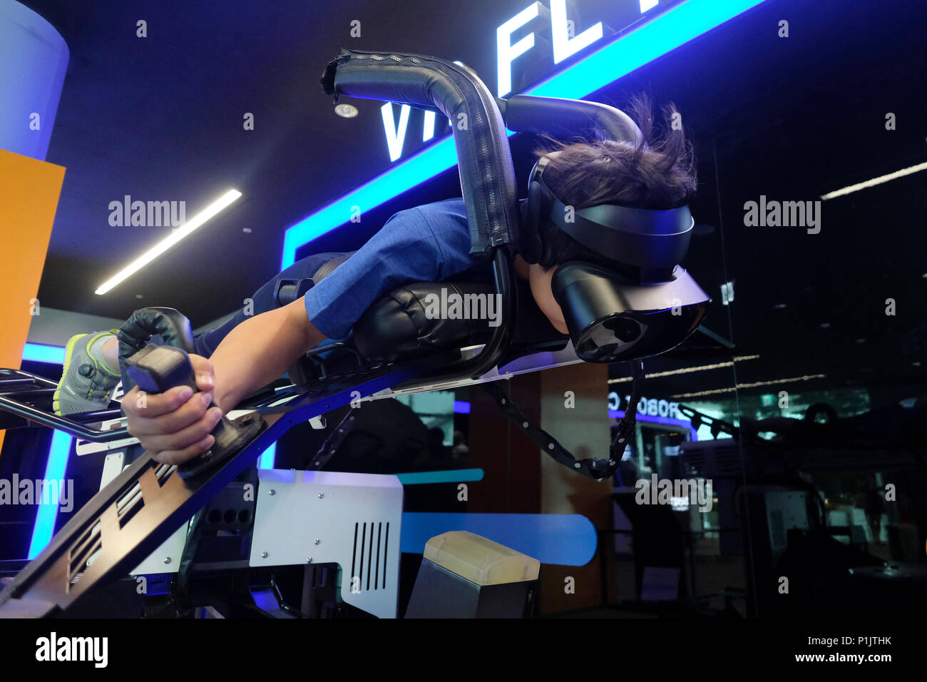 A young passenger using a Virtual Reality (VR) headset interacts with a ...