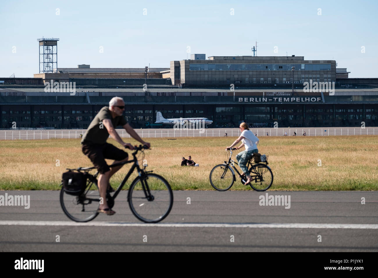 Cyclists on runway at former Tempelhof Airport now public park  in Kreuzberg, Berlin, Germany Stock Photo