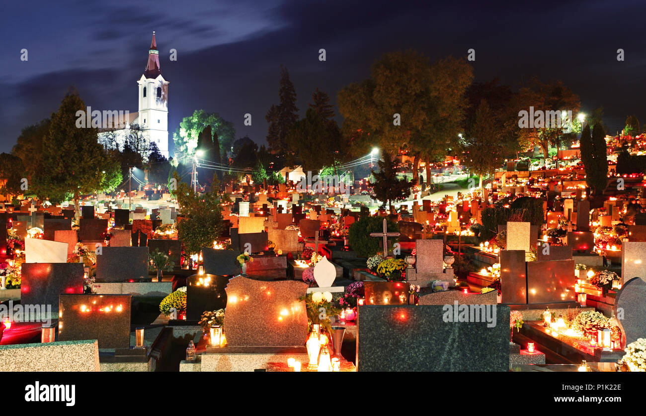 Cemetery at night with many graves and church Stock Photo
