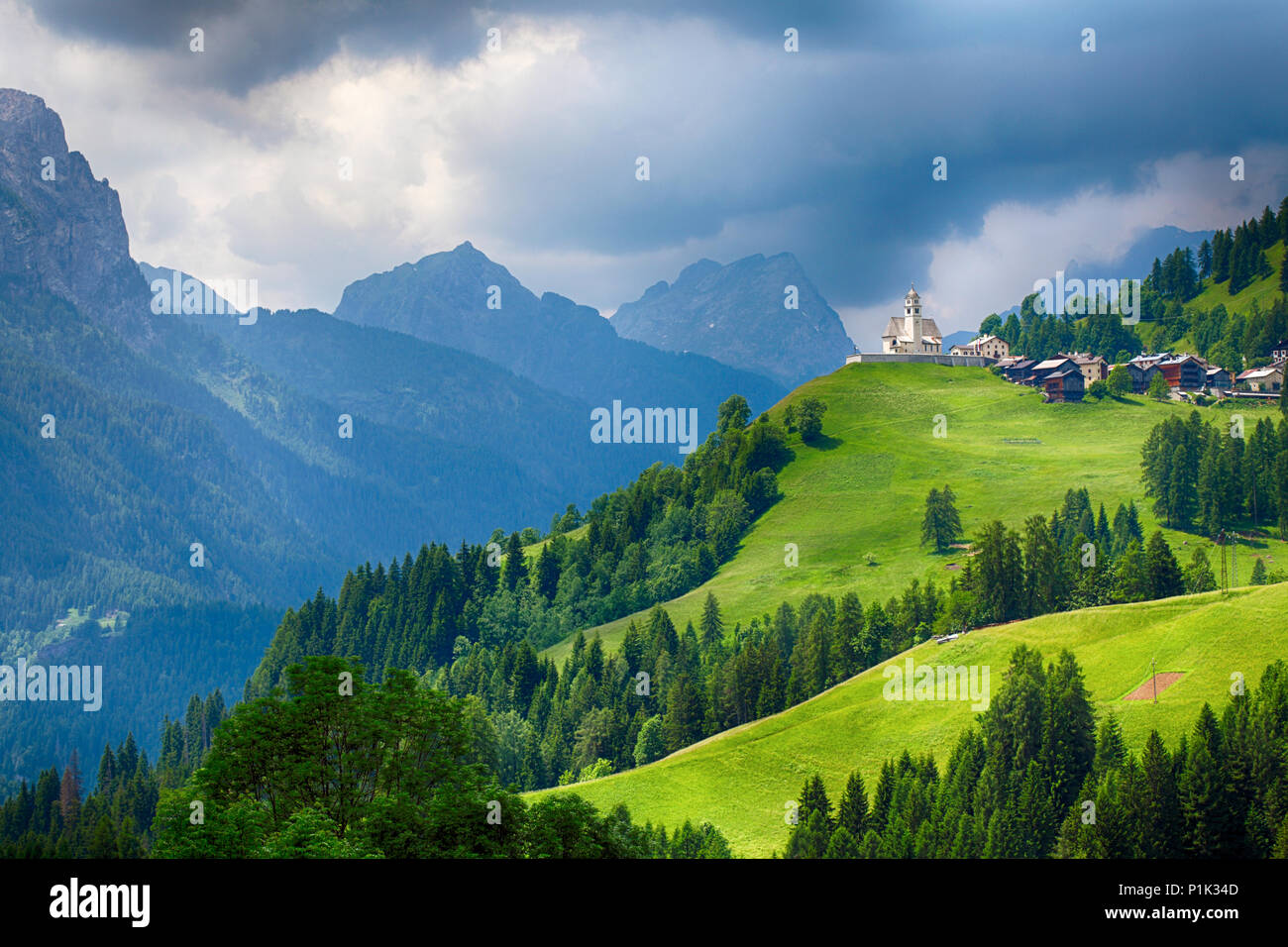 Church in Dolomites alps countryside meadow mountain Stock Photo