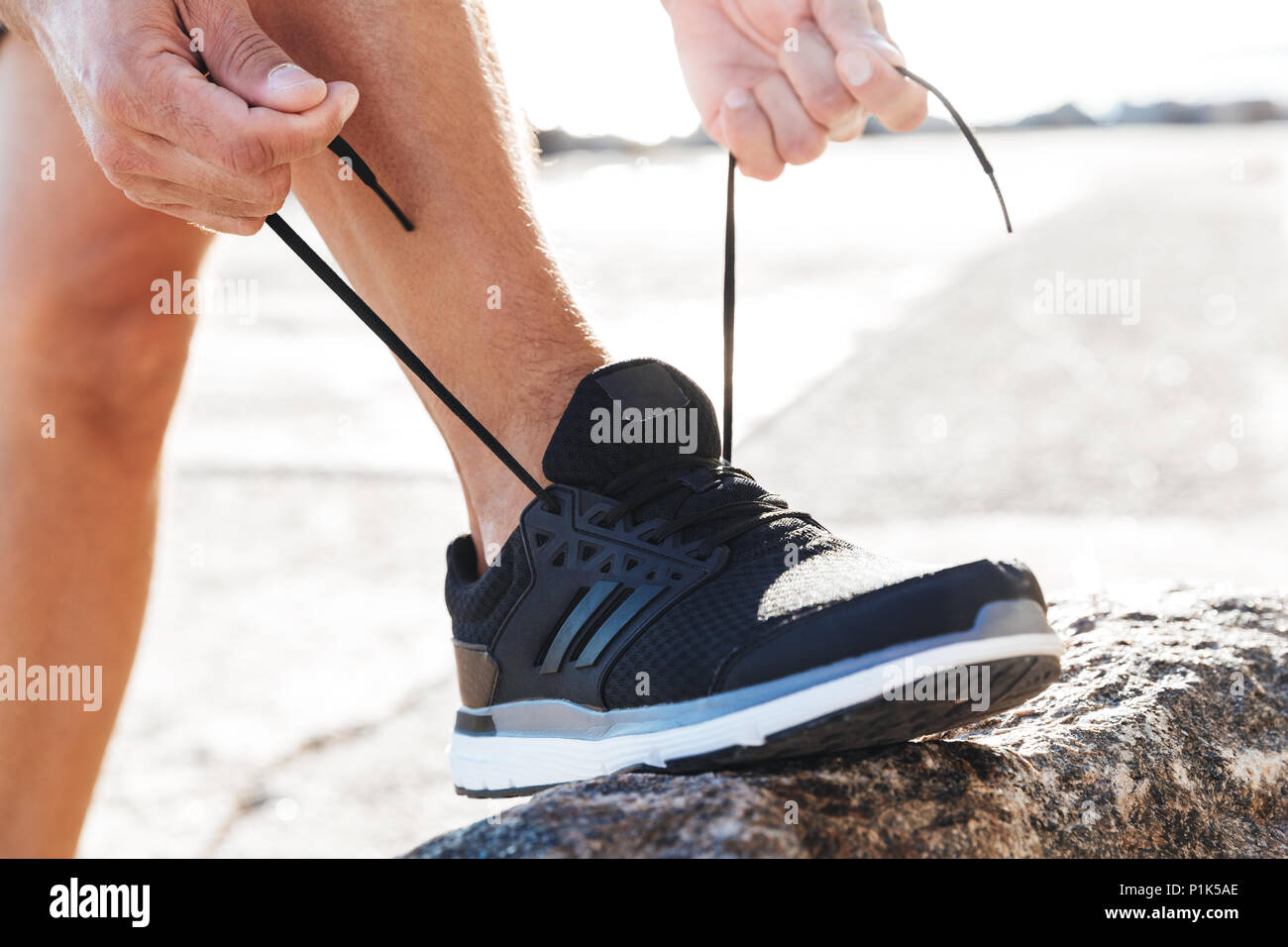 Photo inspiration: Close Up Of A Man Tying Tying Shoelace On His Photo Inspiration