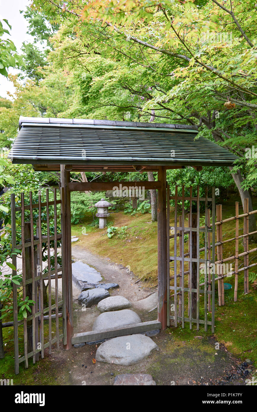 A wooden gate and bamboo fence in a Japanese garden. Stock Photo