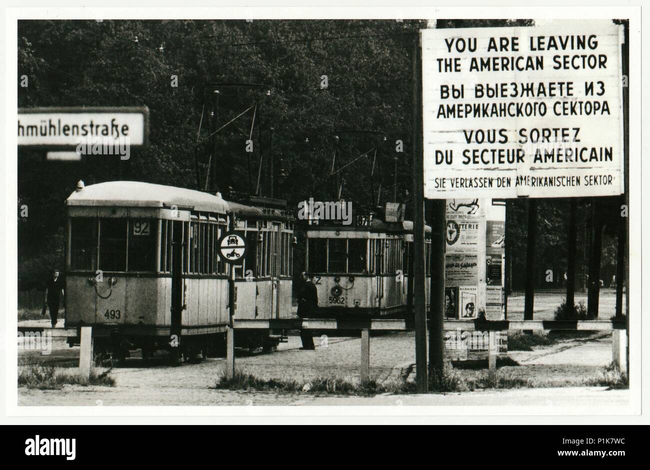 BERLIN, GERMANY - CIRCA 1950s: Vintage photo shows checkpoint between west (American sector) and ost Berlin. Tram leaves American sector. Stock Photo