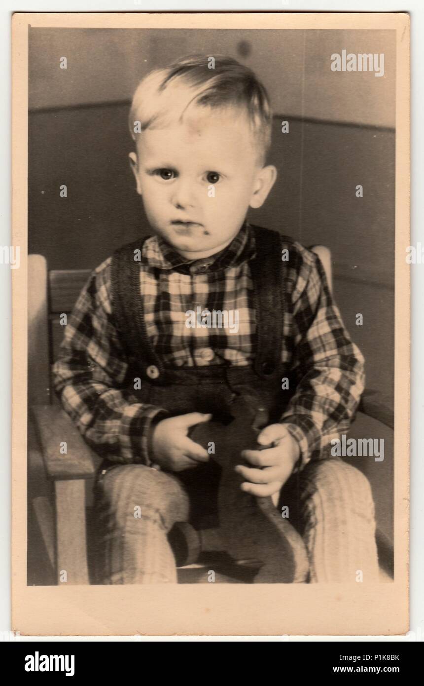THE CZECHOSLOVAK SOCIALIST REPUBLIC - CIRCA 1960s: Vintage photo shows a small boy with wooden toy. Antique black & white photography. 1960s. Stock Photo