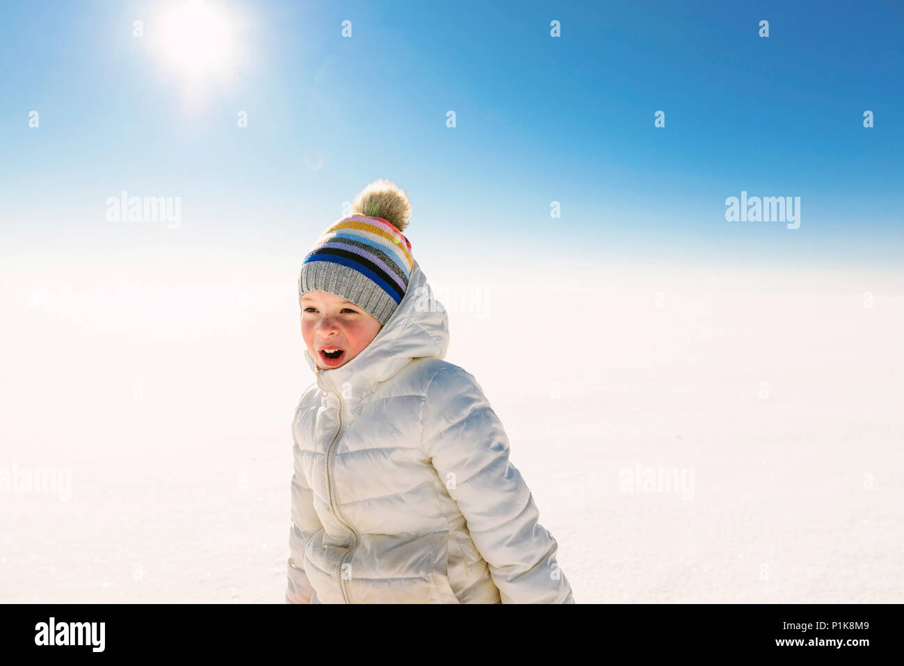 Portrait of a smiling girl standing in the snow Stock Photo - Alamy