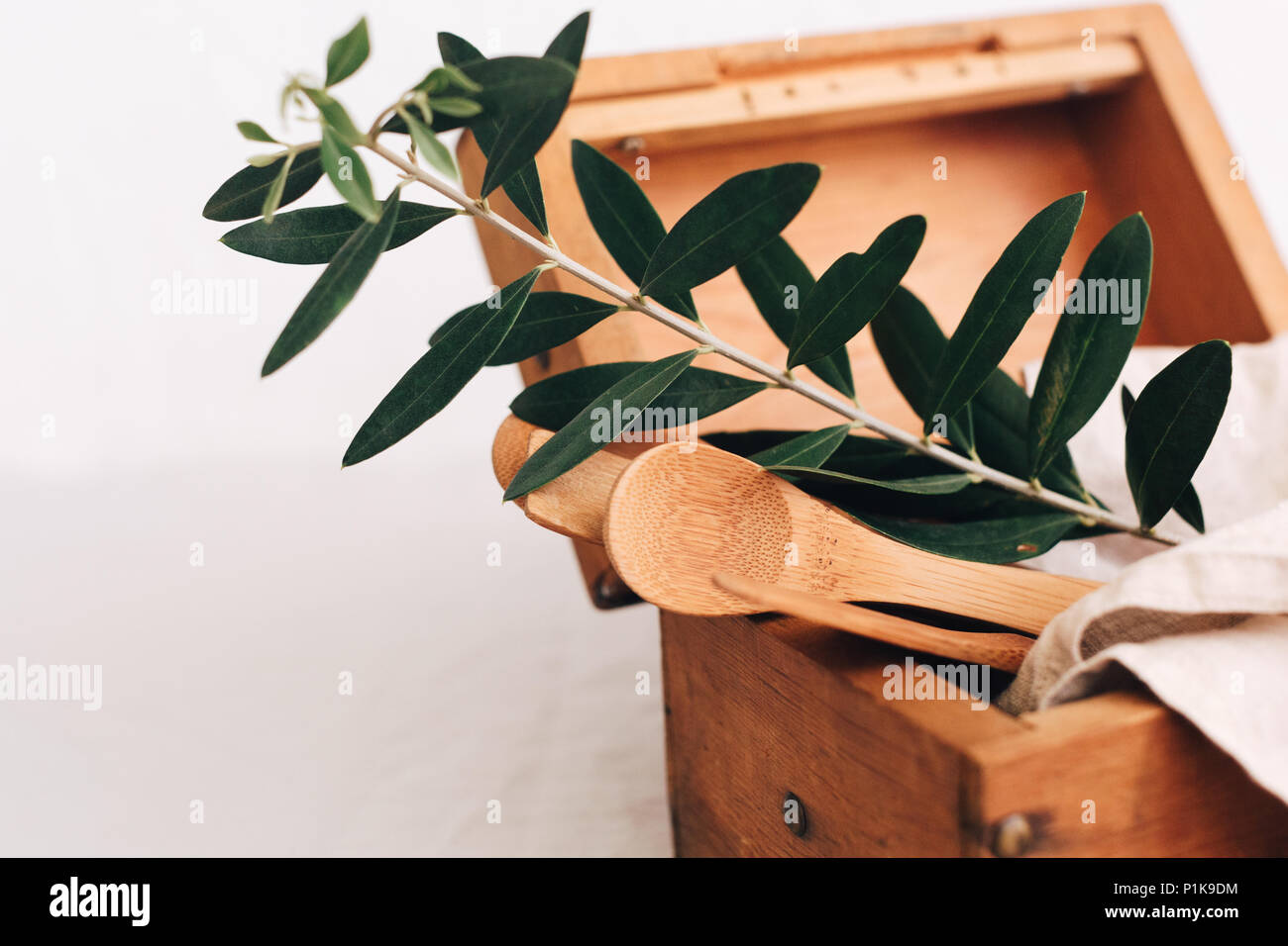 Wooden box with kitchen utensils and a linen napkin Stock Photo