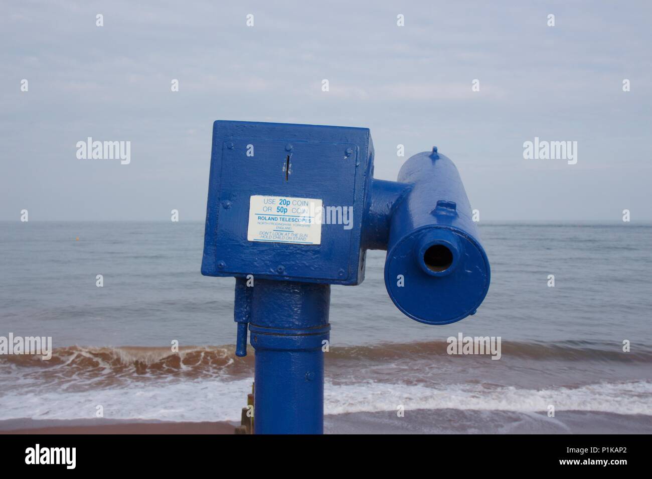 A blue, coin-operated Roland Telescope on Teignmouth seafront, South Devon Stock Photo