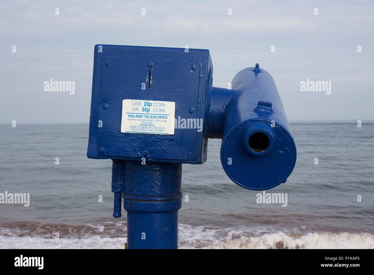 A blue, coin-operated Roland Telescope on Teignmouth seafront, South Devon Stock Photo