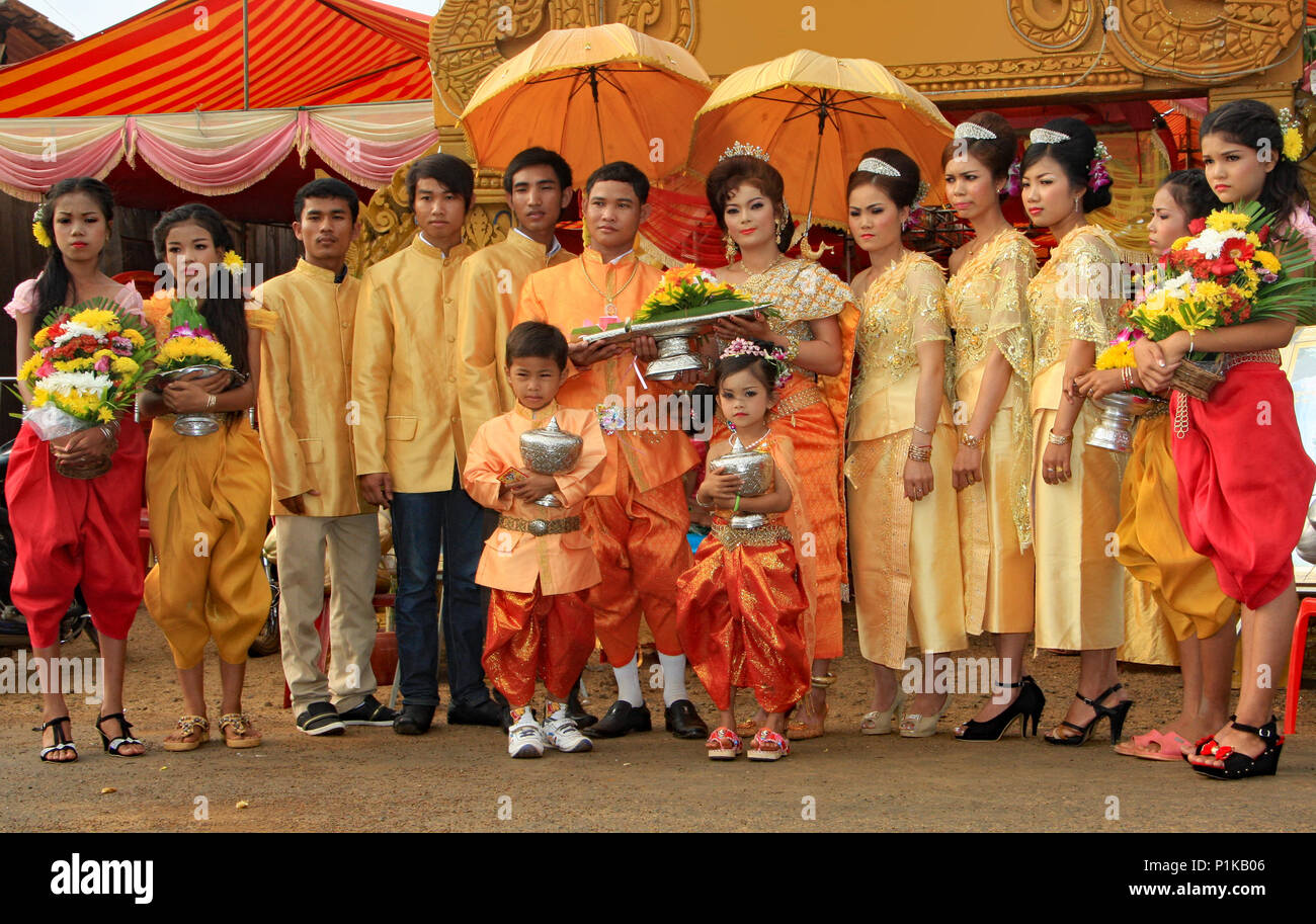Wearing beautiful traditional Khmer wedding clothes the bride and groom with their attendants, pause for a photograph prior to the marriage ceremony. Stock Photo