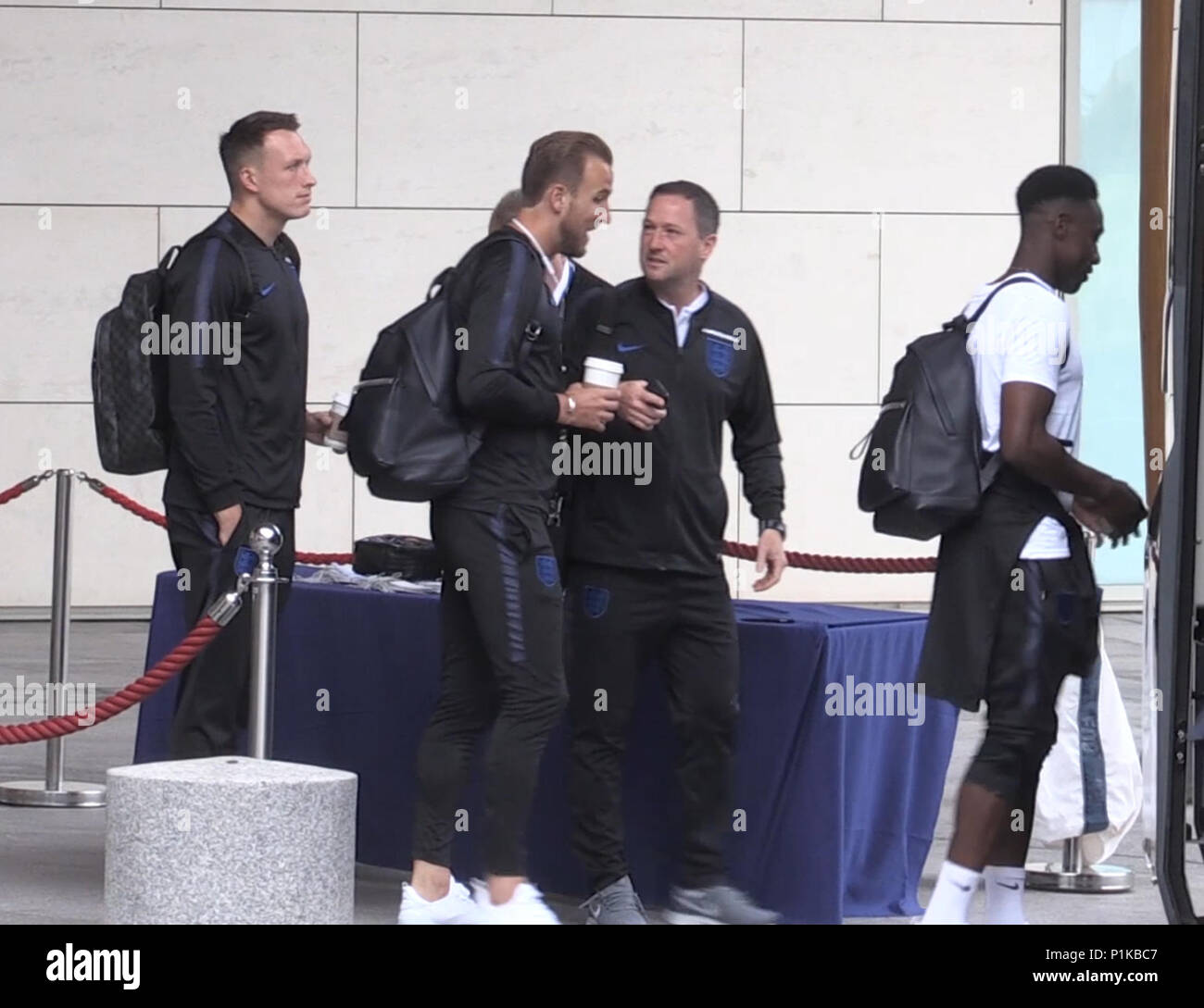 England's Phil Jones (left), Harry Kane (centre left) and Danny Welbeck (right) prepare to board the bus at St George's Park in Burton ahead of flying out to Russia for the 2018 FIFA World Cup. Stock Photo