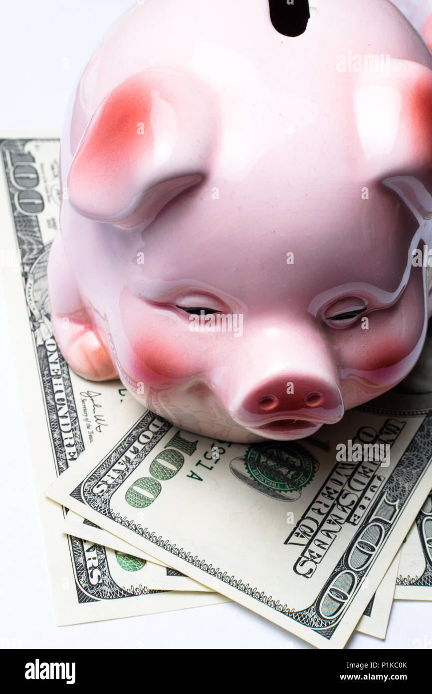 Pink piggy bank with dollar banknotes on white background Stock Photo ...