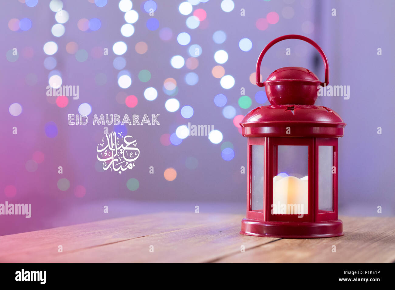 Eid al-Fitr Mubarak Greeting Typography with Bokeh backgound. Arabic lantern on wooden backgound Stock Photo