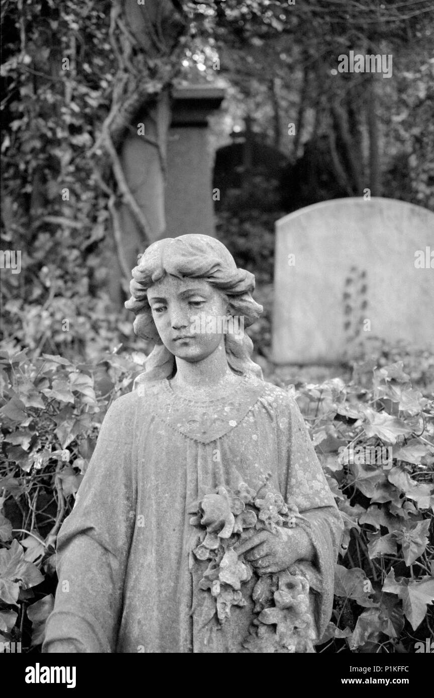 Statue of a girl holding flowers, Highgate Cemetery, Hampstead, London