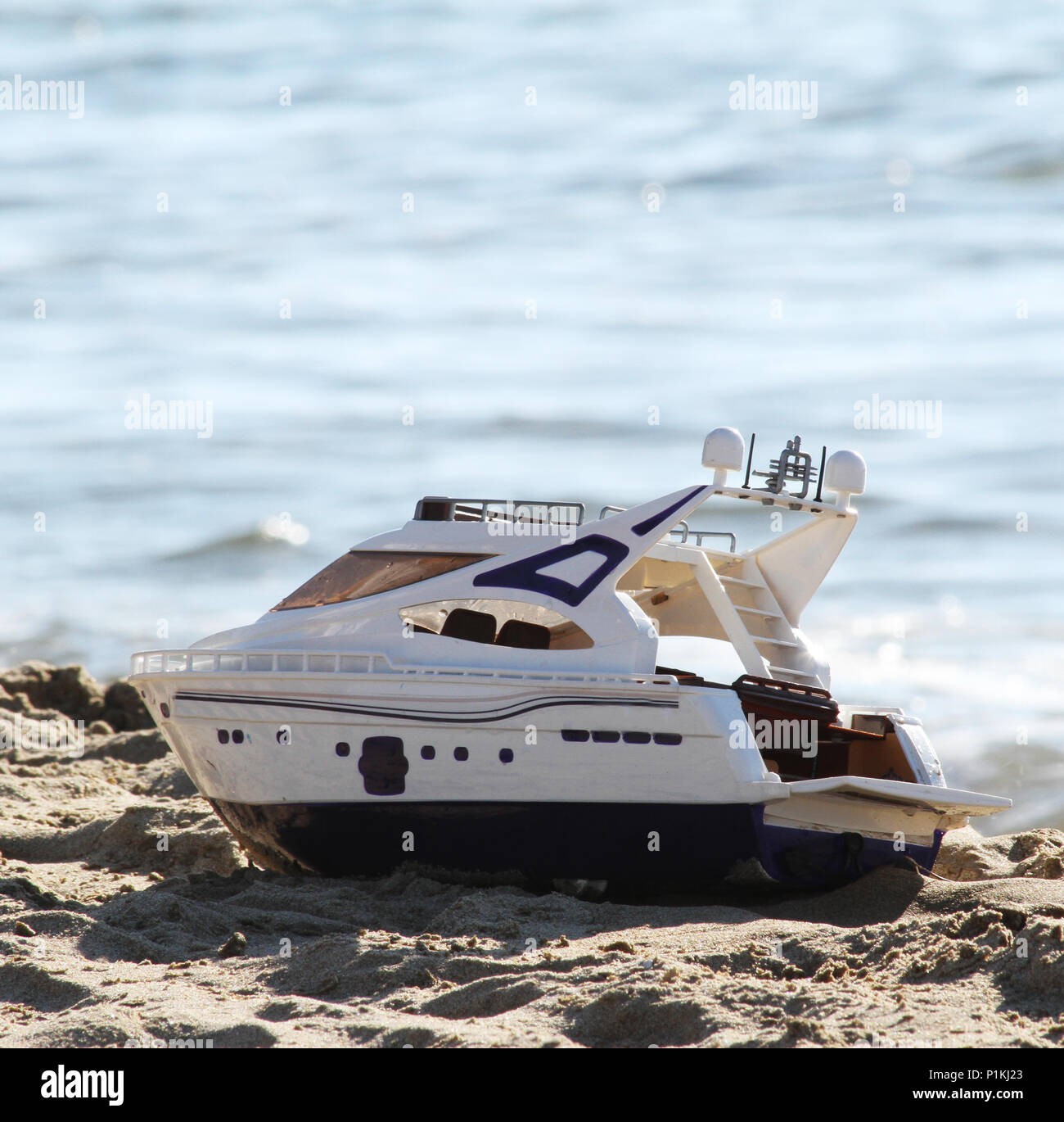 Toy boat on the beach Stock Photo Alamy