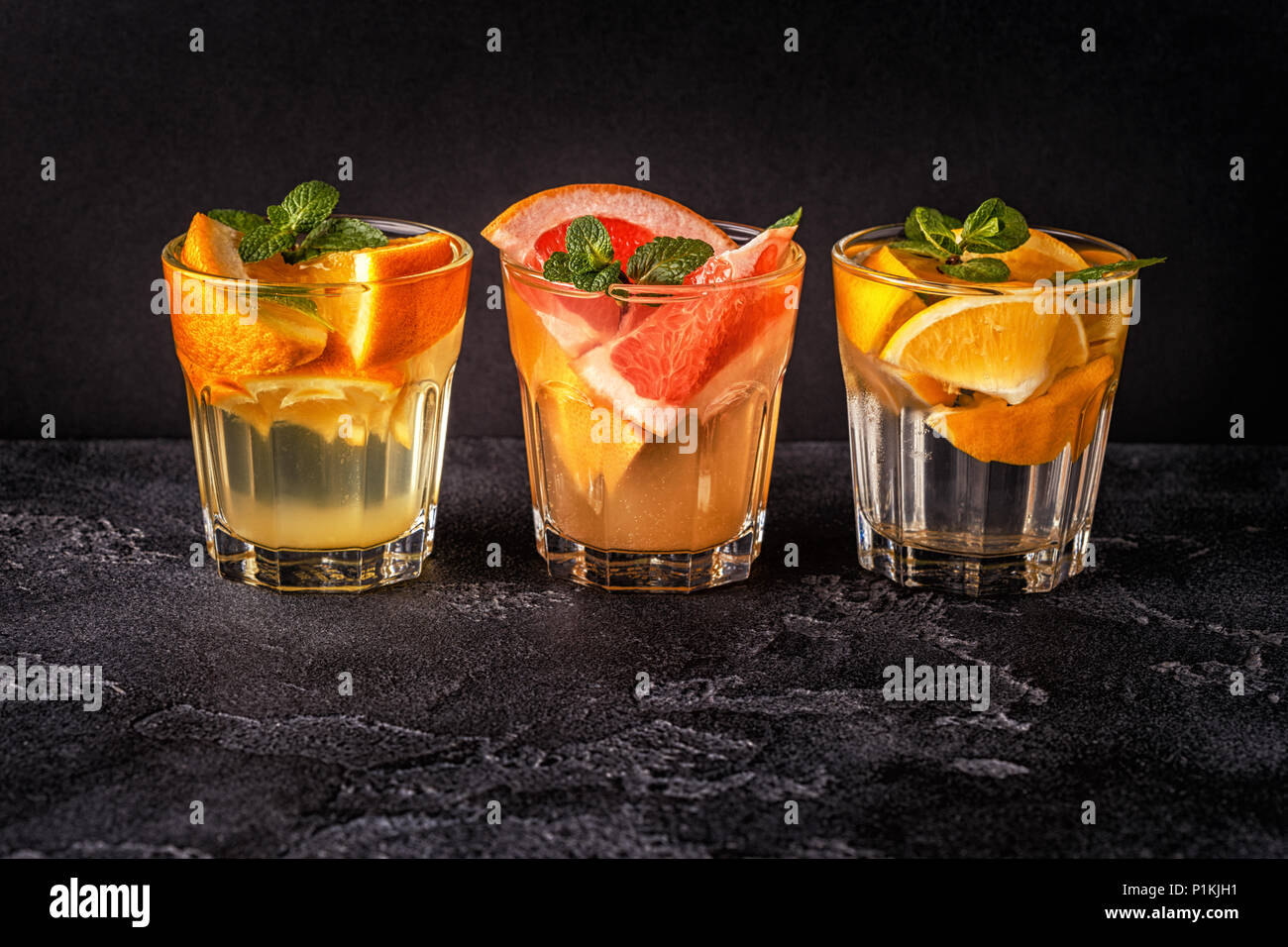 Lemon, grapefruit, orange homemade cocktail/detox fruit infused water, selective focus. Stock Photo