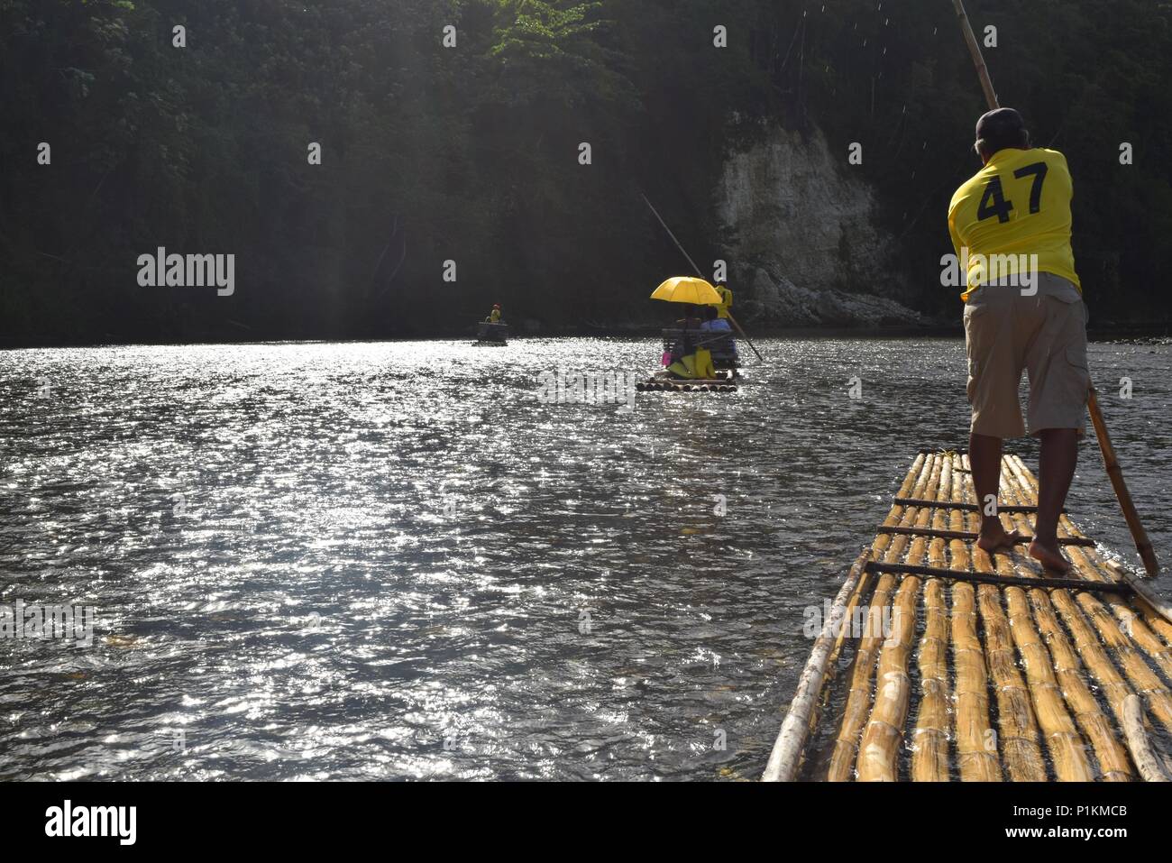 Rio Grande rafters row in sync down the river using hand-made bamboo rafts Stock Photo