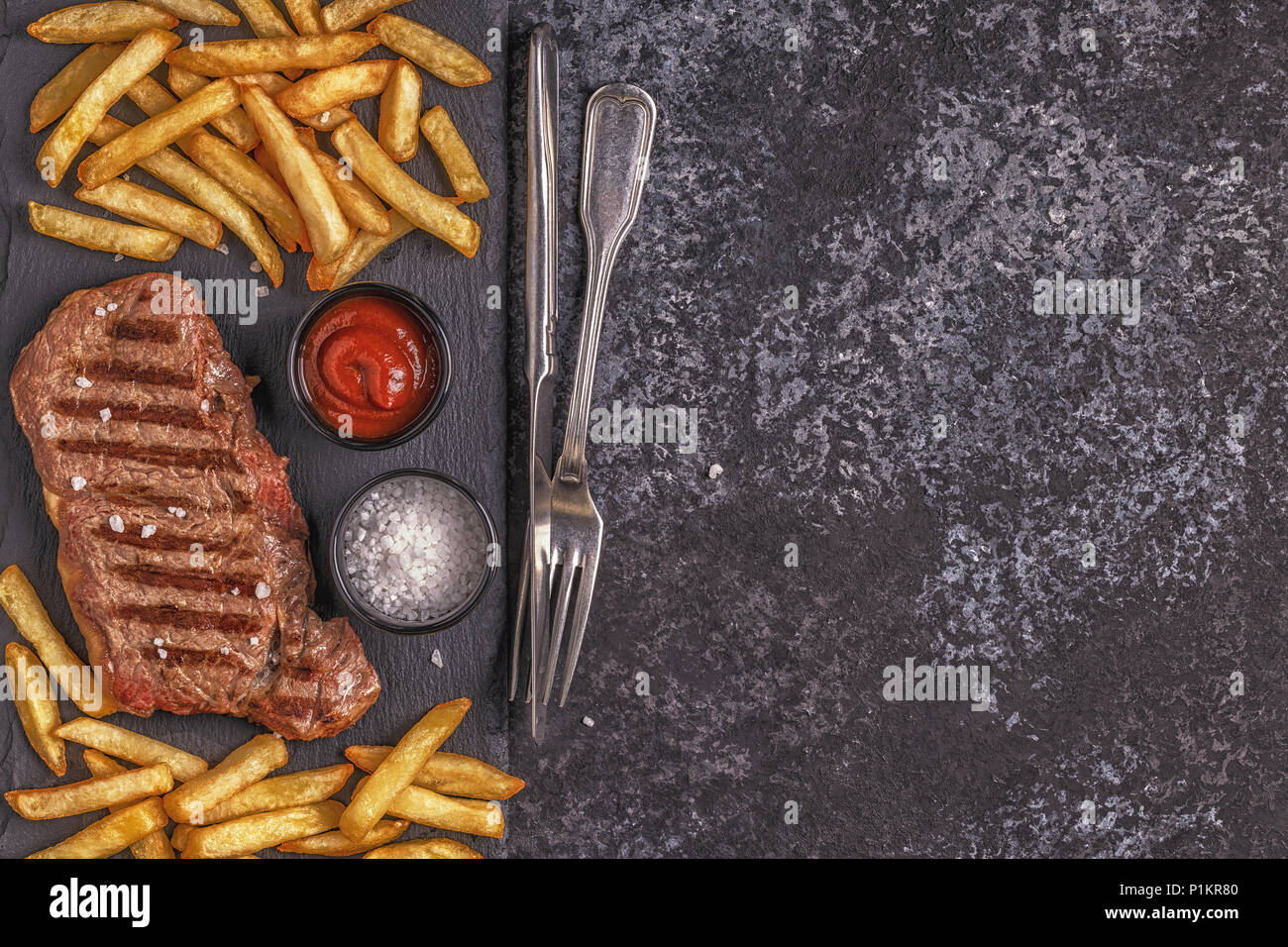 Beef barbecue steak with french fries, top view. Stock Photo