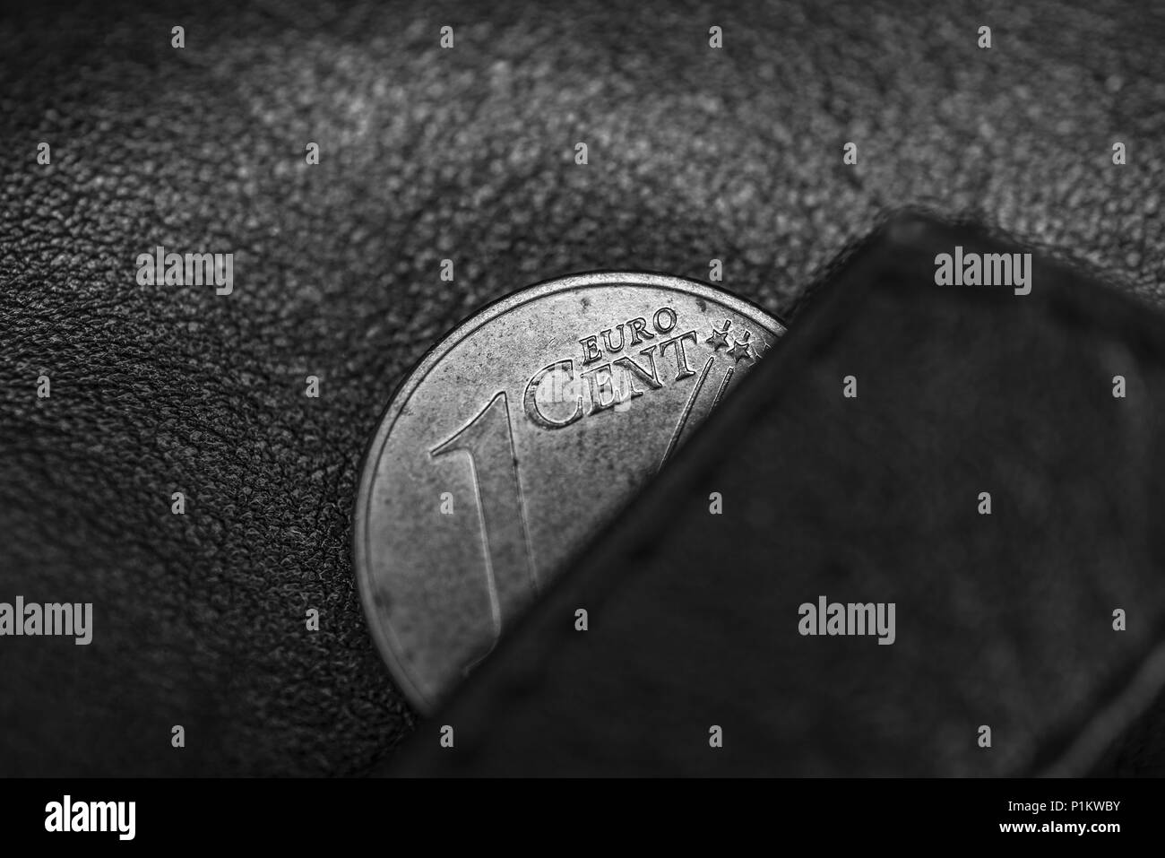 Black and hite photo of black leather wallet and one cent of euro, to symbolize poverty, bankrupt or thrift, frugality and economy Stock Photo