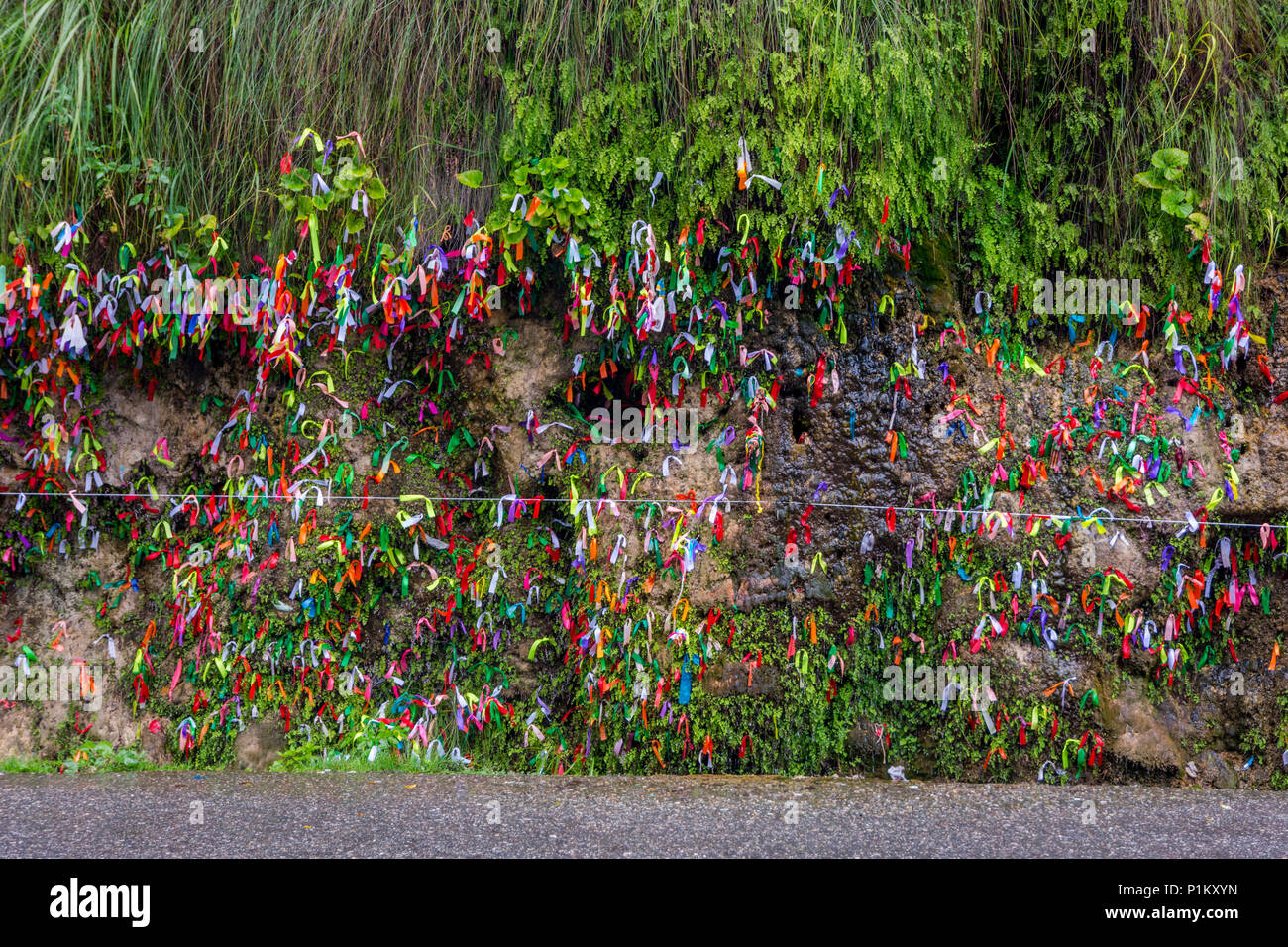 Colorful ribbons for wishes fulfillment on the side of the road in Abkhazia Stock Photo