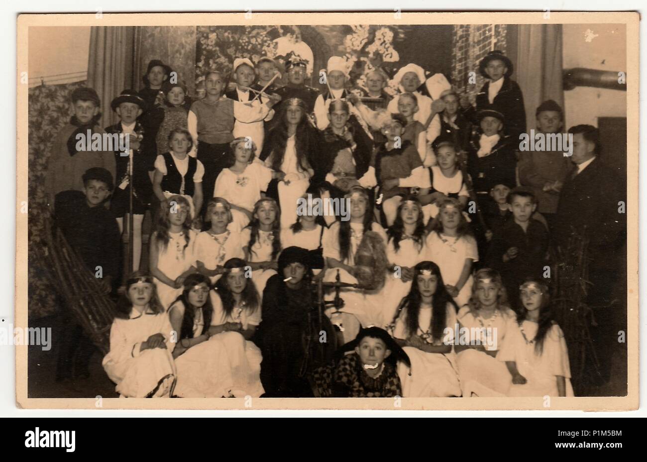 THE CZECHOSLOVAK REPUBLIC - CIRCA 1950s: Vintage photo shows a big group of children with teacher. They wear costums for theatre performance. Stock Photo