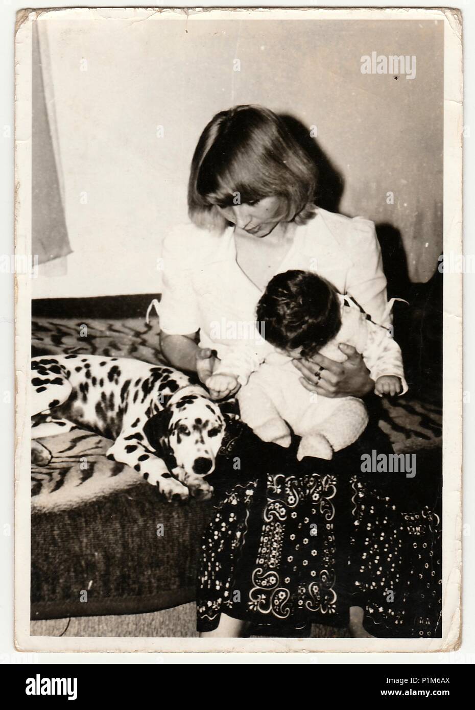 THE CZECHOSLOVAK SOCIALIST REPUBLIC - CIRCA 1970s: Retro photo shows child,  mother and dog who sit on sofa. Black & white vintage photography Stock  Photo - Alamy