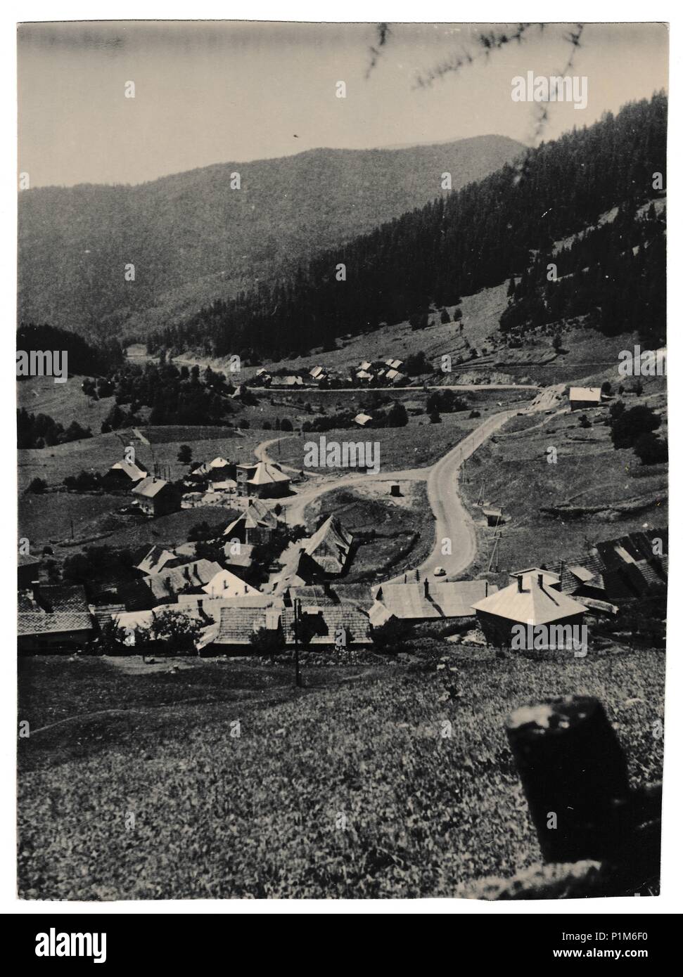 DONOVALY, THE CZECHOSLOVAK SOCIALIST REPUBLIC - CIRCA 1960s: Retro photo shows view on mountain village. Black & white vintage photography Stock Photo