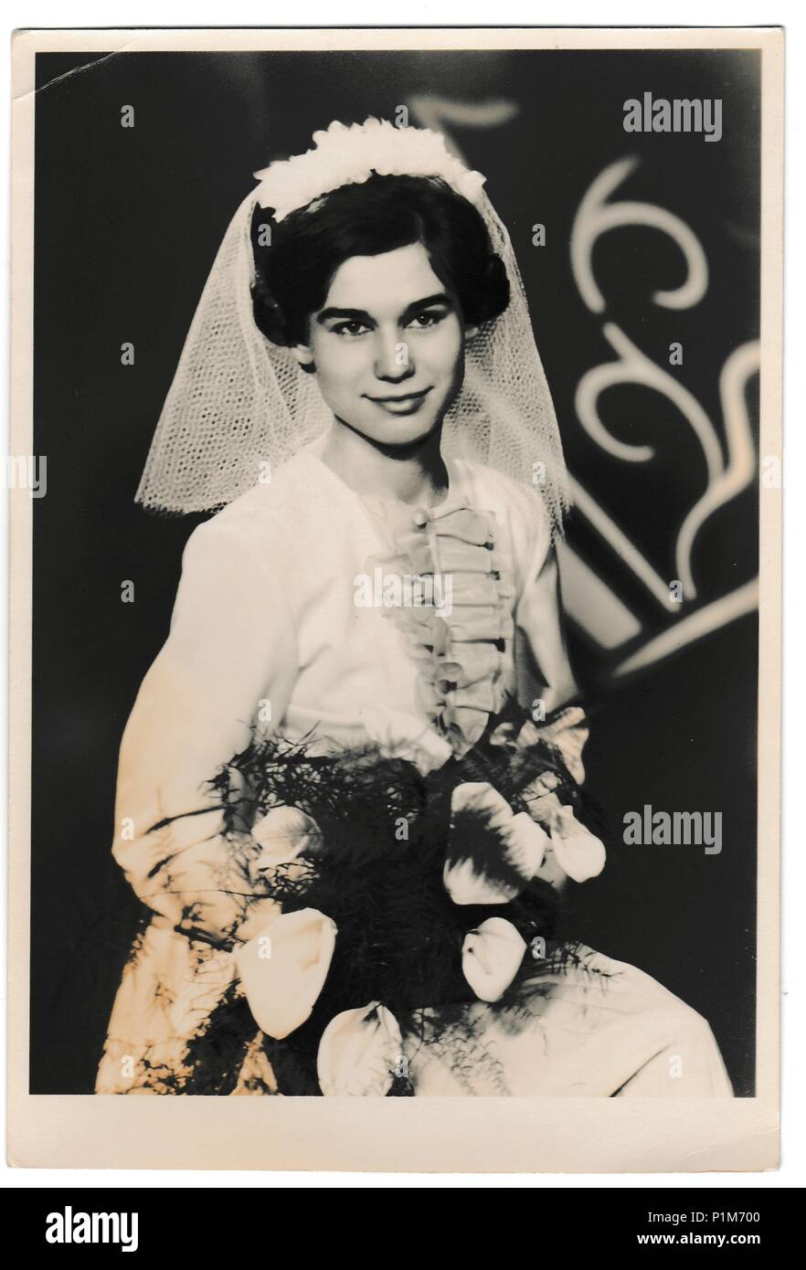 THE CZECHOSLOVAK SOCIALIST REPUBLIC - APRIL 4, 1964: Retro photo shows bride with white kala flowers. Black & white vintage photography. Stock Photo