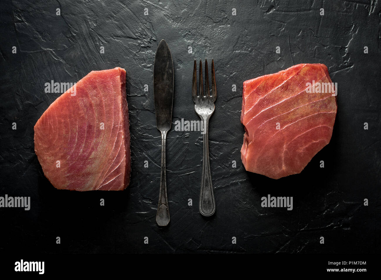 Raw Tuna Steak on Dark Stone Background Stock Photo