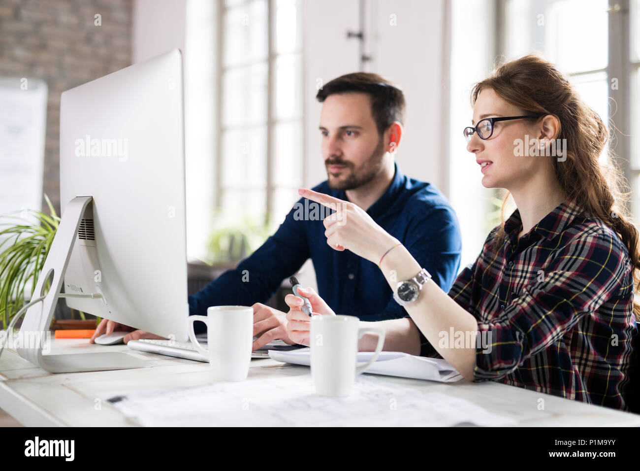 Young architects working on project in office Stock Photo