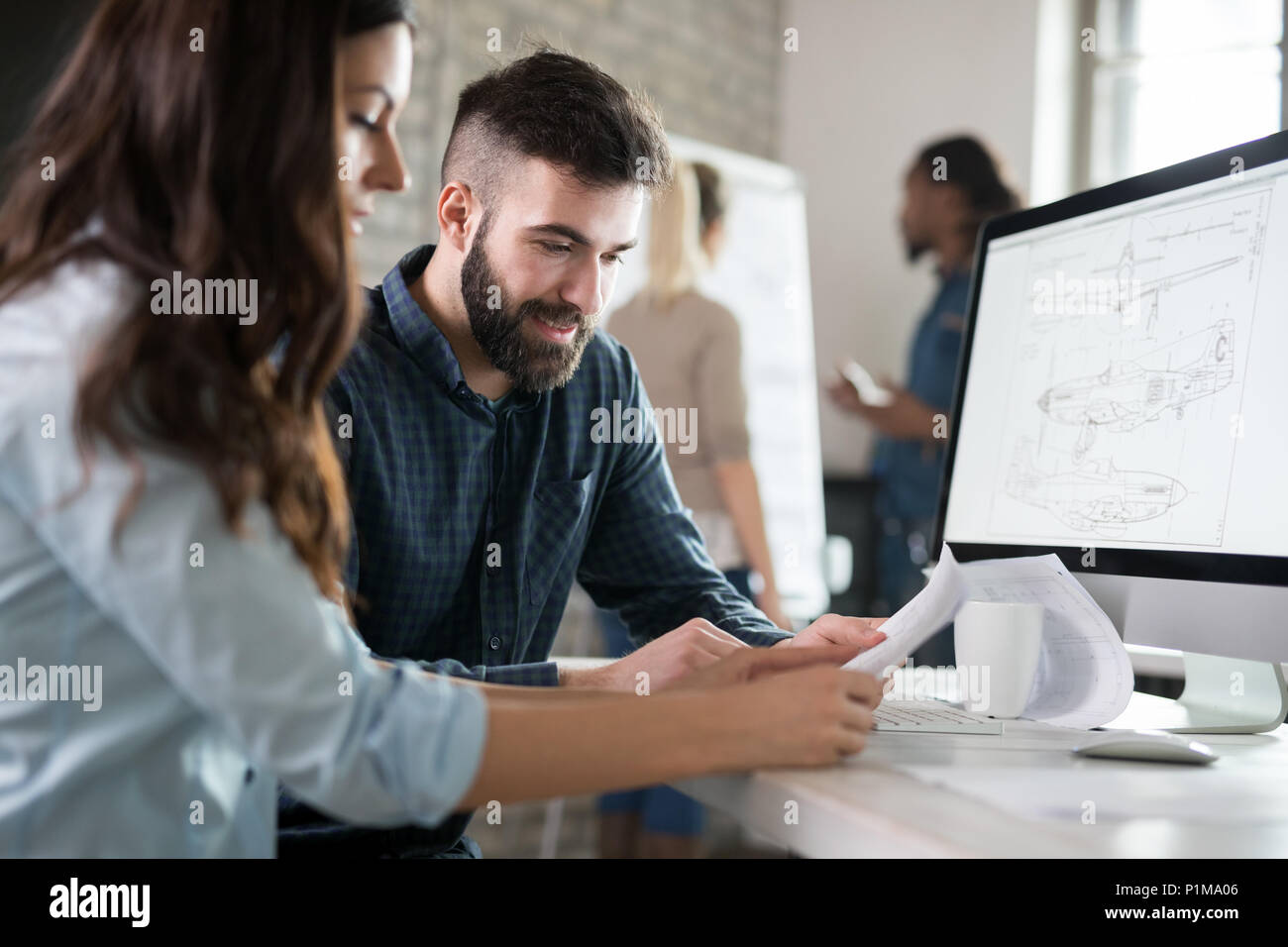 Young architects working on project in office Stock Photo