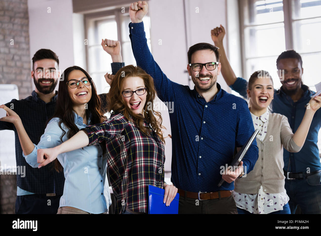 Portrait of successful business team posing in office Stock Photo - Alamy