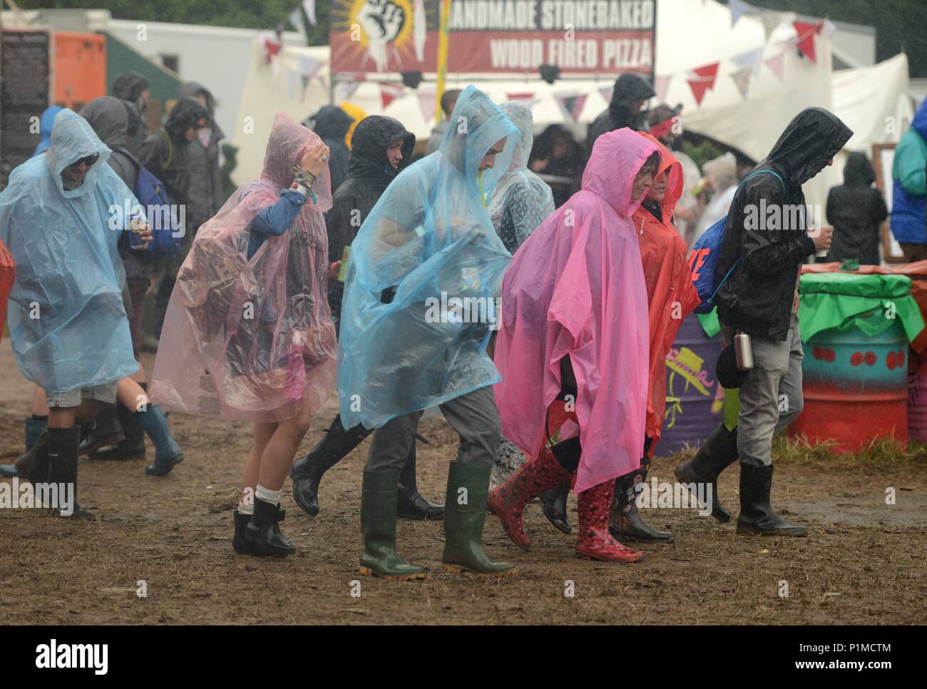 Revelers enjoy the rain at Glastonbury Festival 2015 Friday Stock
