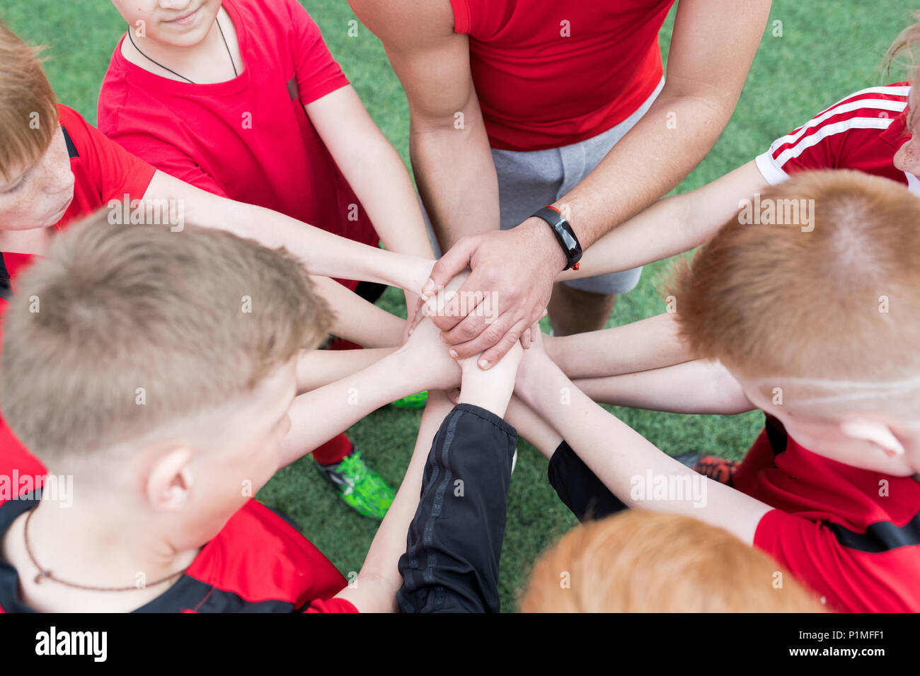 Junior Sports Team Joining Hands Stock Photo Alamy