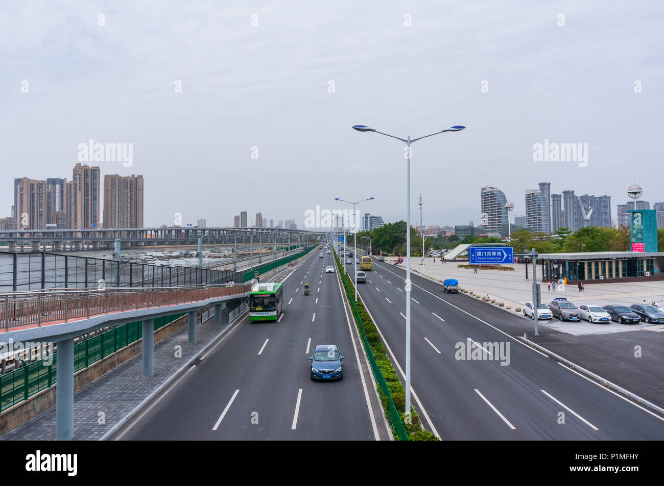 Xiamen, China - Apr 07, 2018: Timelapse, Car Traffic And Running Subway At Seaside Near Xiamen Garden Expo Stock Photo