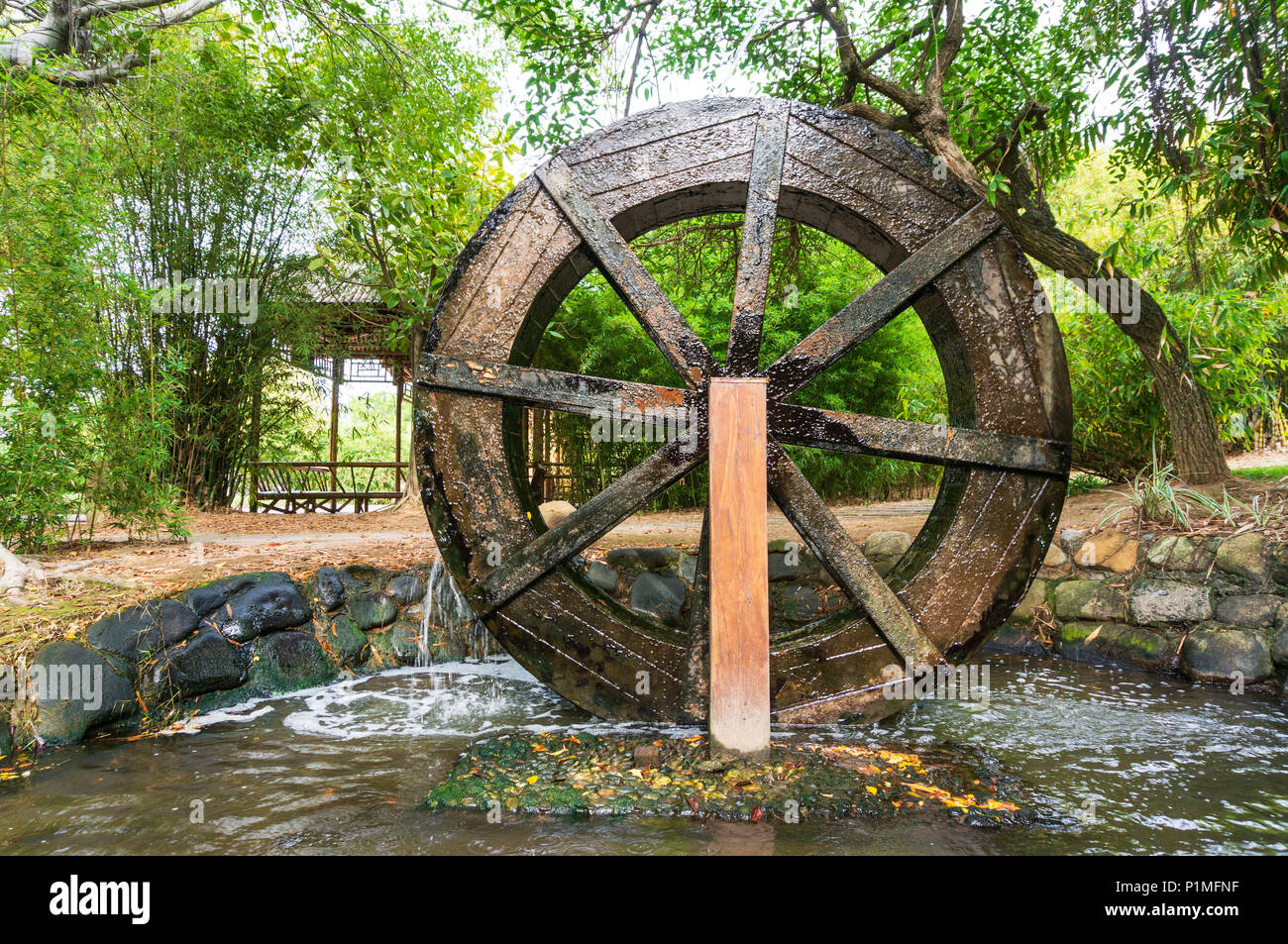 Wooden Wheel of Ancient Water Mill in Village Stock Photo