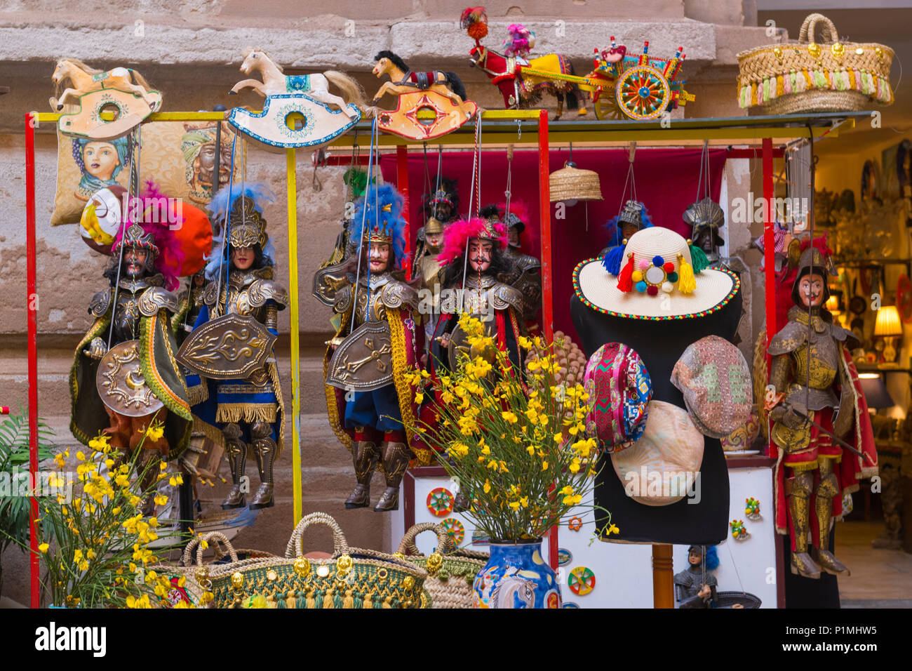 Italy Sicily Palermo street scene shop store pavement sidewalk display typical string puppets old military uniforms hats small rocking horses Stock Photo