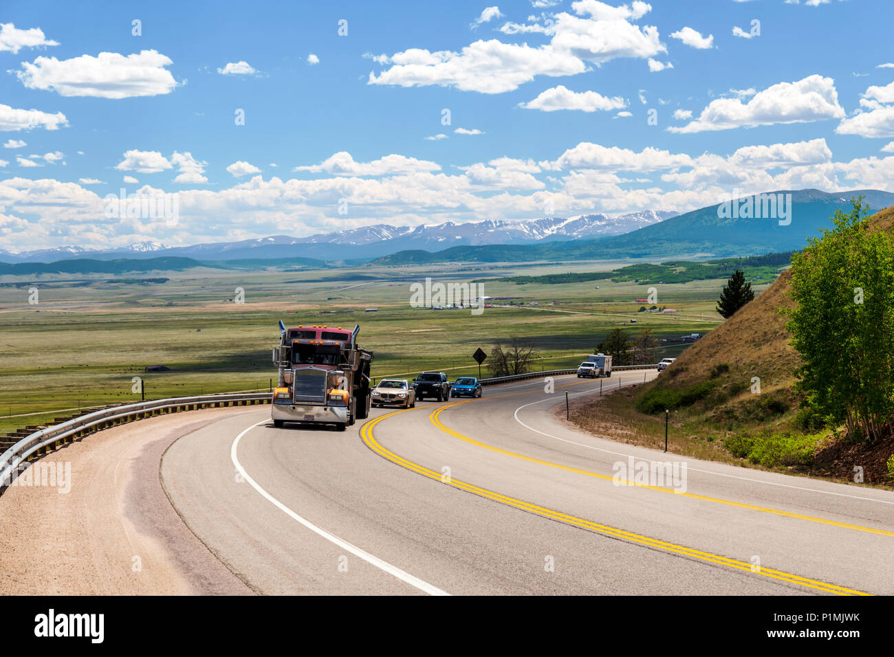 Tractor trailer on highway 285 with South Park valley beyond; from Kenosha Pass; central Colorado; USA Stock Photo