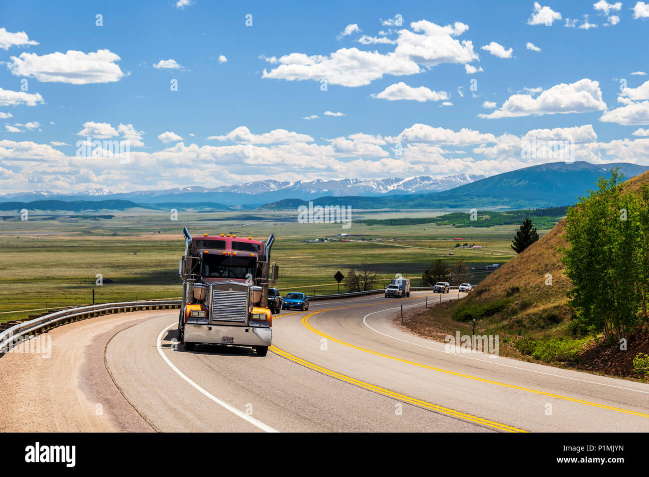 Tractor trailer on highway 285 with South Park valley beyond; from Kenosha Pass; central Colorado; USA Stock Photo