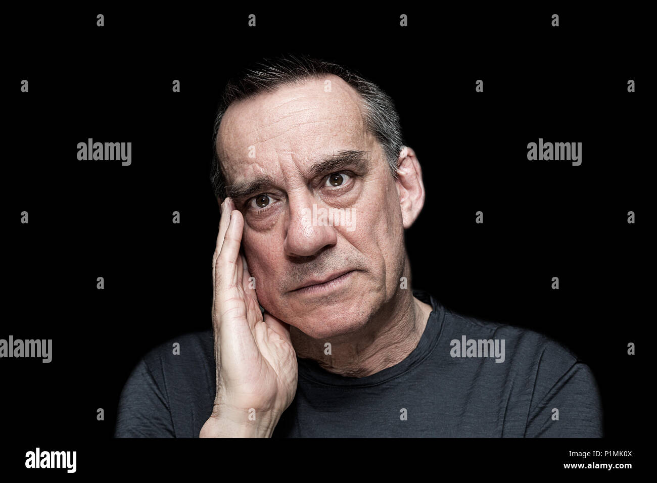 Closeup High Contrast Portrait of Angry Frustrated Man on Black Background Stock Photo